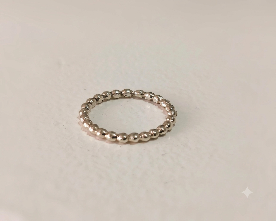 Delicate 9ct white gold beaded stacking ring with a textured bubble motif displayed flat on a plain light background.