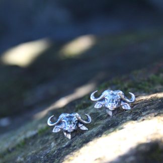 Buffalo stud earrings on wood